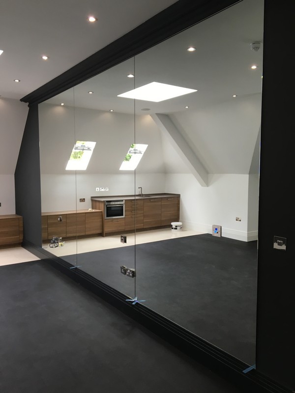 Frameless glass partition in loft conversion by Clerkenwell glaziers